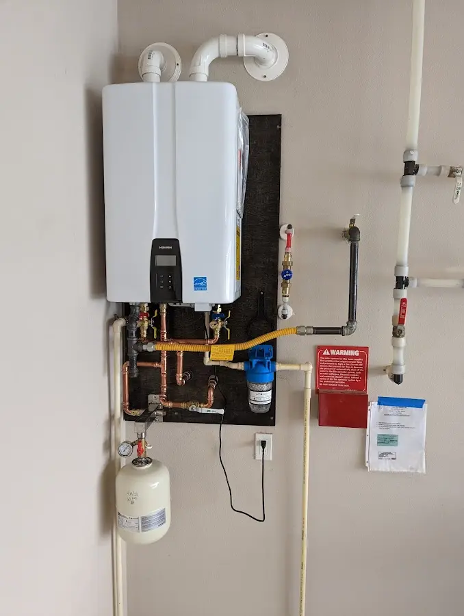 Professional plumber installing copper piping in a Forest home